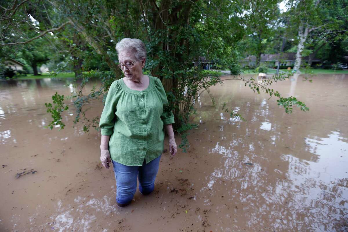 Anice Divin, 71, walks just feet from her front porch at Greenwood and Strange Drive Monday, May 30, 2016, in Richmond. Divin has lived in the area for 49 years and never seen water up to her home before this weekend.