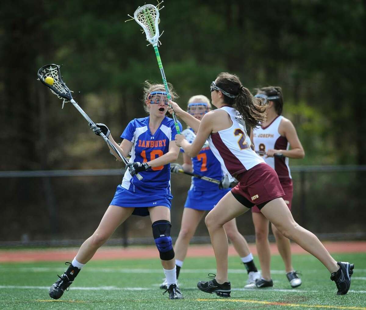 Danbury's Andrea Tarsi, left is defended by St. Joseph's Julie DoCarmo during Tuesday's girls lacrosse matchup at St. Joseph High School in Trumbull.