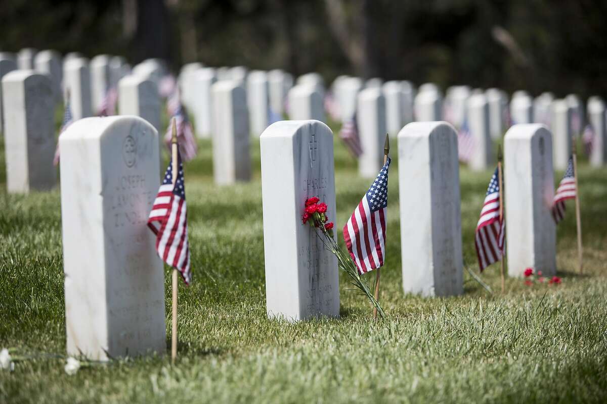 Flags and flowers placed on graves during the annual Memorial Day Ceremony at the San Francisco National Cemetery in the Presidio, May 30, 2016.