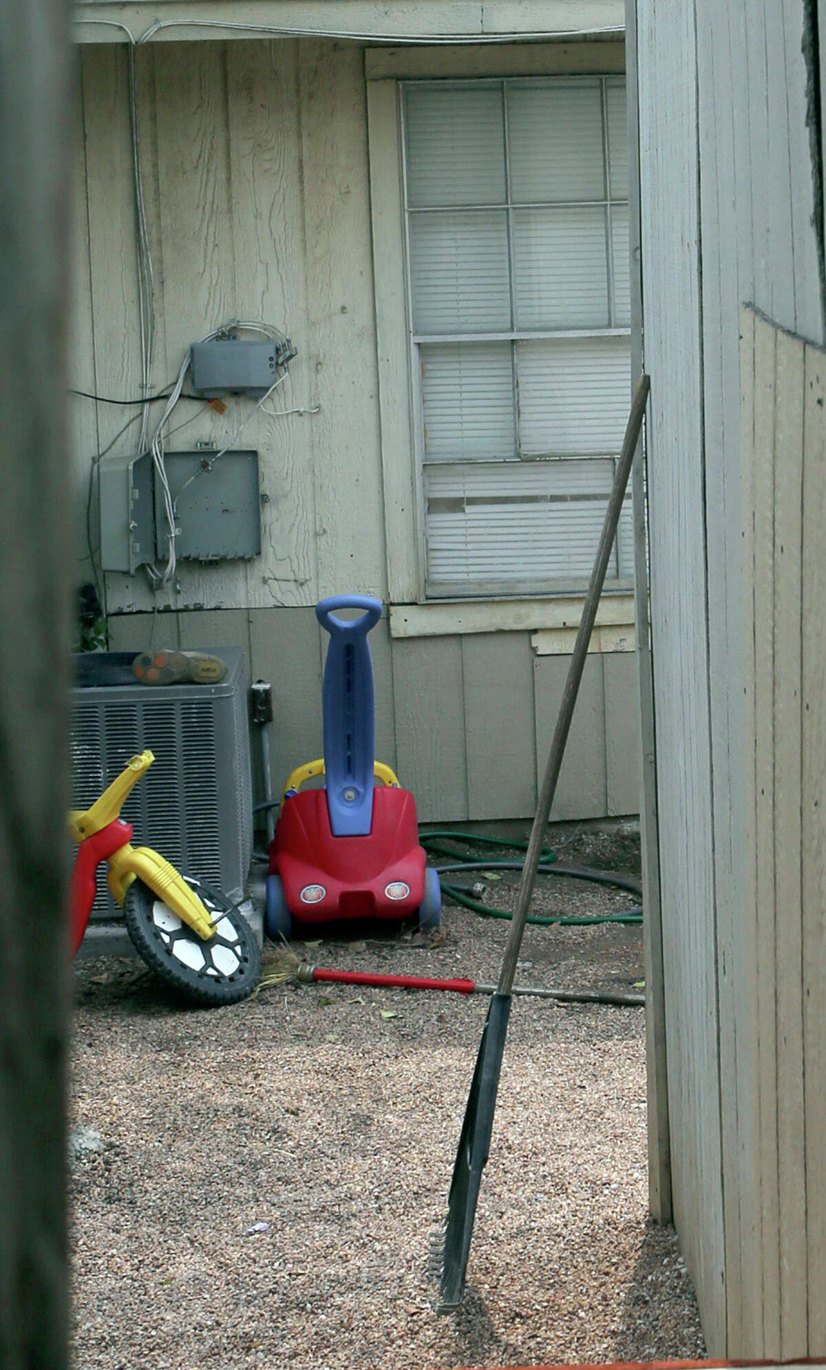 This is the back yard of the townhouse at 8105 Chipping in San Antonio, Texas, Friday, April 29, 2016, where children were allegedly chained up in the back yard. Authorities say they have arrested a woman who is the mother of six of eight children who were found unsupervised in the middle of the night at a San Antonio home. A spokesman for the Bexar County sheriff's office says the 34-year-old woman also was supposed to be looking after two other children who were found tied up in the backyard. (John Davenport/The San Antonio Express-News via AP)