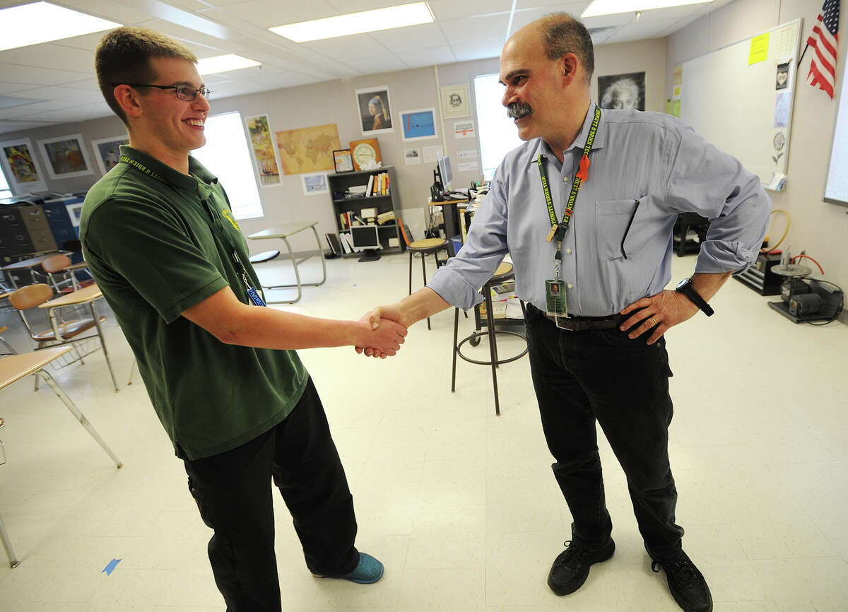 Emmett O'Brien Tech valedictorian Sean Coyle, of Ansonia, shakes hands with his physics teacher, Paul Garmirian, at the school in Ansonia, Conn. on Thursday, March 31, 2016. Coyle, who plans to study engineering, will be the first of the school's graduates to attend The U.S. Military Academy at West Point.