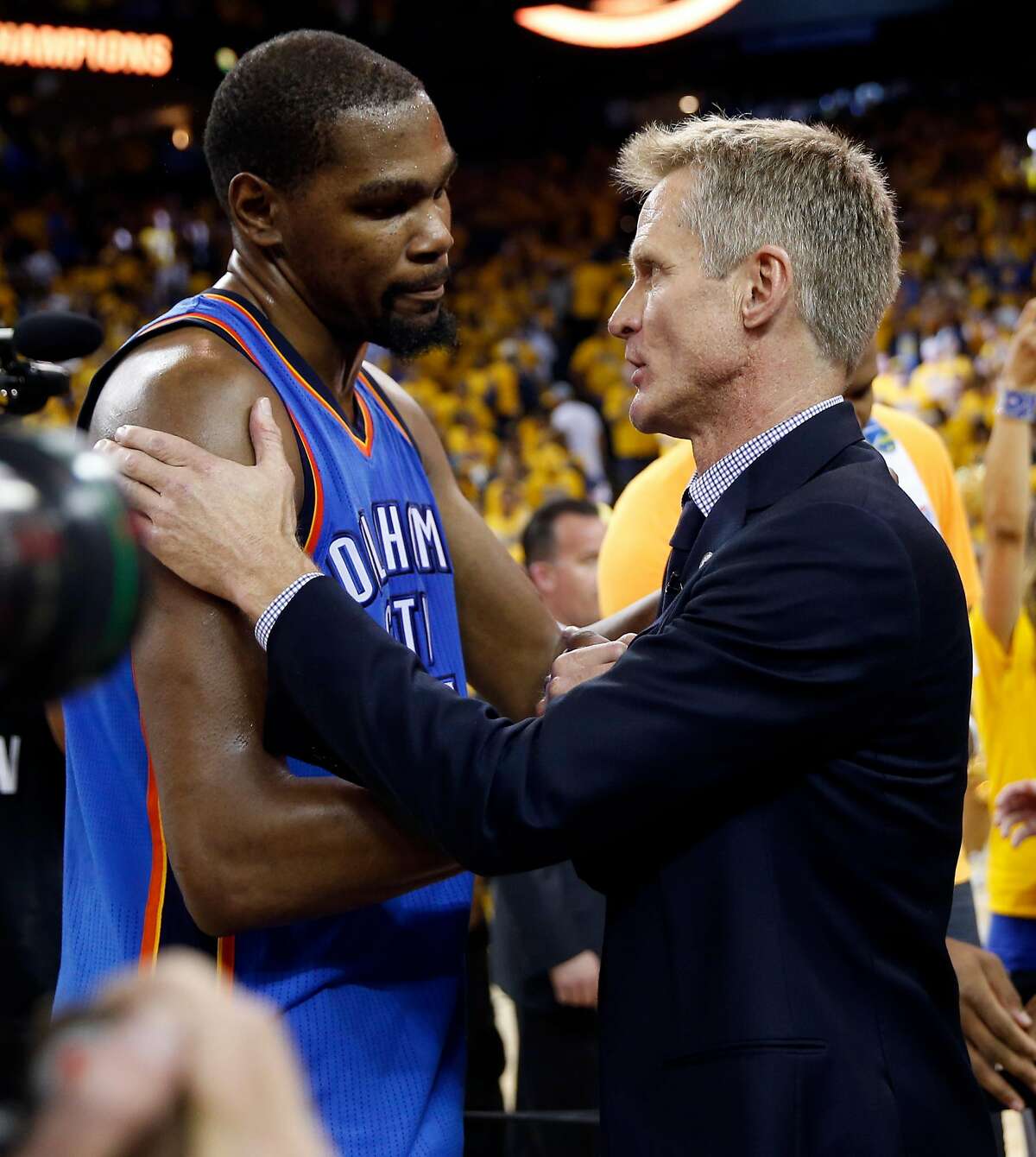 Golden State Warriors' head coach Steve Kerr and Oklahoma City Thunder's Kevin Durant meet after Warriors' 96-88 win in Game 7 of NBA Playoffs' Western Conference finals at Oracle Arena in Oakland, Calif., on Monday, May 30, 2016.