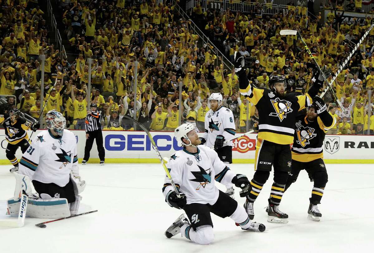 Pittsburgh's Nick Bonino, right, celebrates with after beating San Jose goalie Martin Jones, left, with 2:33 remaining in the third period and lifting the Penguins to a 3-2 victory in Game 1 of the Stanley Cup Final.