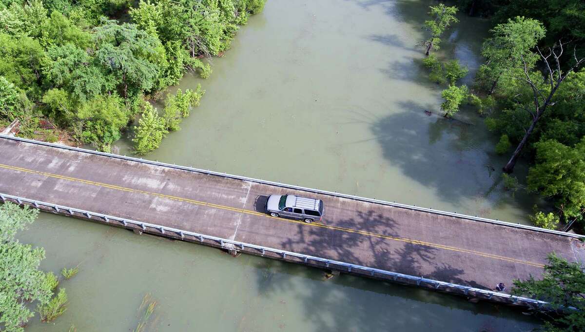 County Road 261 crosses Diversion Lake just down stream from Medina Lake as seen May 31, 2016 in an aerial image taken with a remote control quadcopter. Water began flowing over the Medina Lake spillway about 6 p.m. Monday, May 30. On May 31, 2015 Medina Lake was 51.5 percent full according to data from the Texas Water Development Board. Instantaneous water readings as of 6 p.m. Tuesday show the lake to be .9 feet into flood stage and that it has been rising for the last 48 hours.