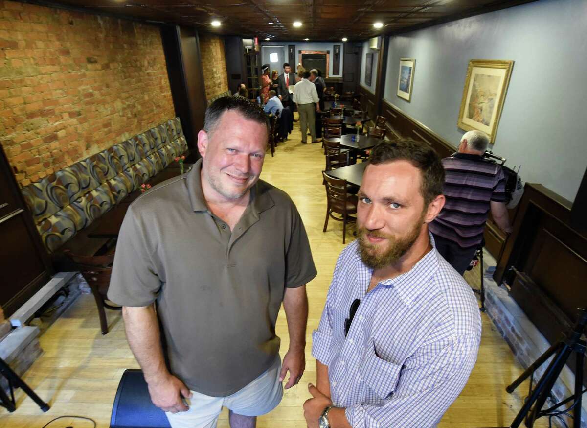 Savoy Taproom owner Jason Pierce, left, and Daniel Atkins stand in the renovated dining room of the Savoy restaurant in 2016 in Albany, N.Y. Pierce has expressed concerns about how those struggling with homelessness, addiction and mental illness who come to his bar can be helped. (Skip Dickstein/Times Union)