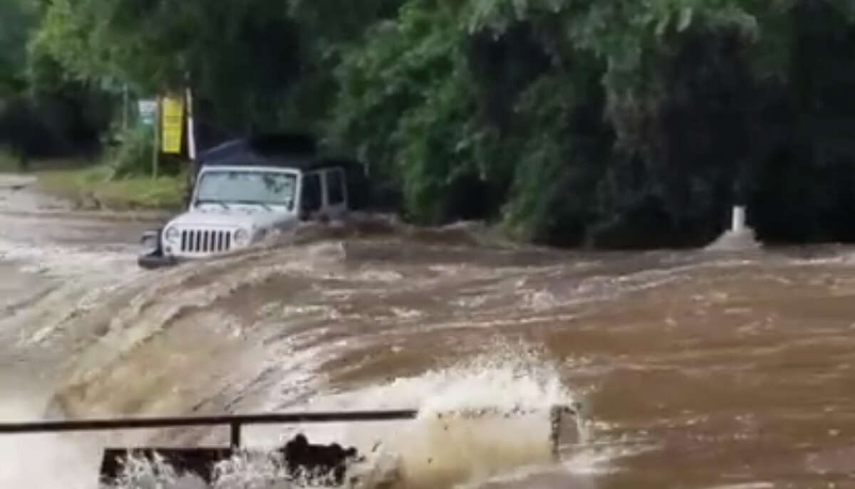 Video taken at the first crossing on River Road in New Braunfels, Texas, near Jerry's Rentals, shows a Jeep swept off the road by high water and downstream.