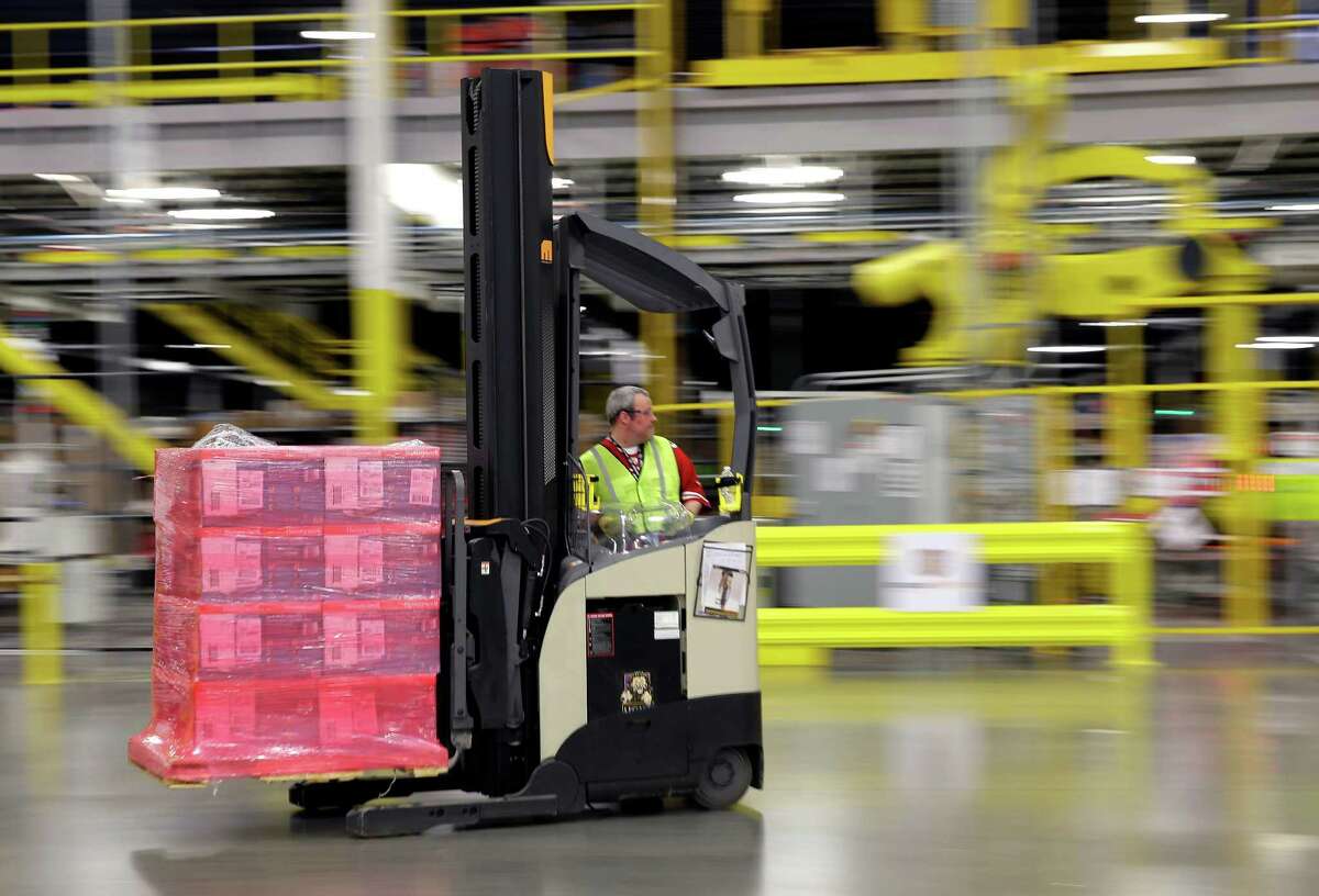 A forklift operator moves a pallet of goods at an Amazon.com fulfillment center in DuPont, Wash. in this Feb. 13, 2015, file photo. The online retail giant is hiring fulfillment associates, software developer managers, senior financial analysts and human resources managers among other positions for its San Marcos center.