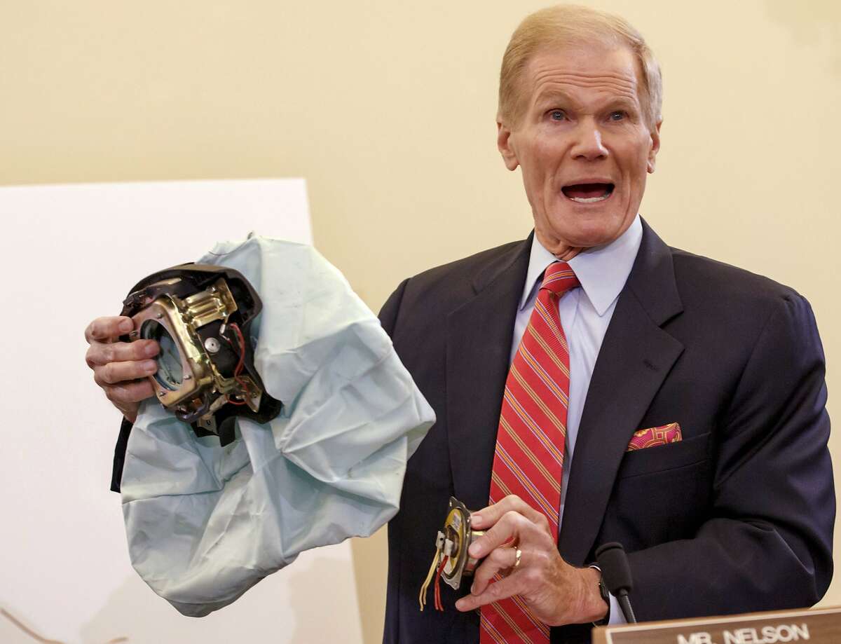 FILE - In this Nov. 20, 2014, file photo, Senate Commerce Committee member Sen. Bill Nelson, D-Fla., holds an example of a defective air bag made by Takata of Japan that has been linked to multiple deaths and injuries in cars driven in the U.S., during a hearing on Capitol Hill in Washington. A U.S. Senate report says at least four automakers are selling new vehicles, from the 2016 and 2017 model years, that have potentially deadly Takata air bag inflators. Nelson said the automakers should replace the inflators before the cars are sold so they don't eventually have to be recalled. But the cars currently aren't under recall and can be sold legally. (AP Photo/J. Scott Applewhite, File)