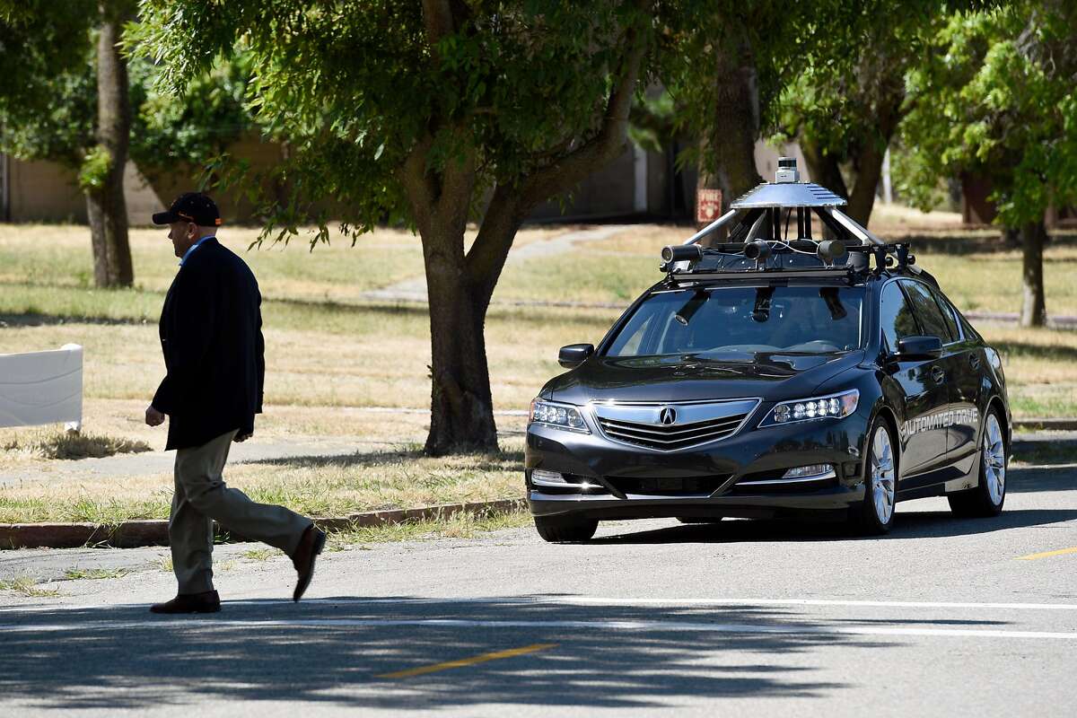 Jack Hall of the Contra Costa Transportation Authority acts as a pedestrian crossing in front of an Accura RLX self-driving car during a demonstration at GoMentum Station, Honda's 5,000-acre self-driving car proving grounds at the old Concord Naval Weapons Station, in Concord, CA Wednesday, June 1st, 2016.