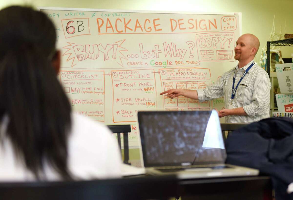 Upper School Design teacher Phil Lohmeyer shows project guidelines for the sixth-grade Design class' branding and packaging project at Whitby School in Greenwich, Conn. Tuesday, May 24, 2016. Students came up with an original product and designed the product packaging and advertising for the product.