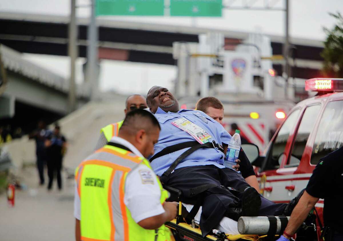 A Metro operator who was riding as a passenger on a Metro bus involved in an accident is removed by emergency workers, Wednesday, June 1, 2016, in Houston.