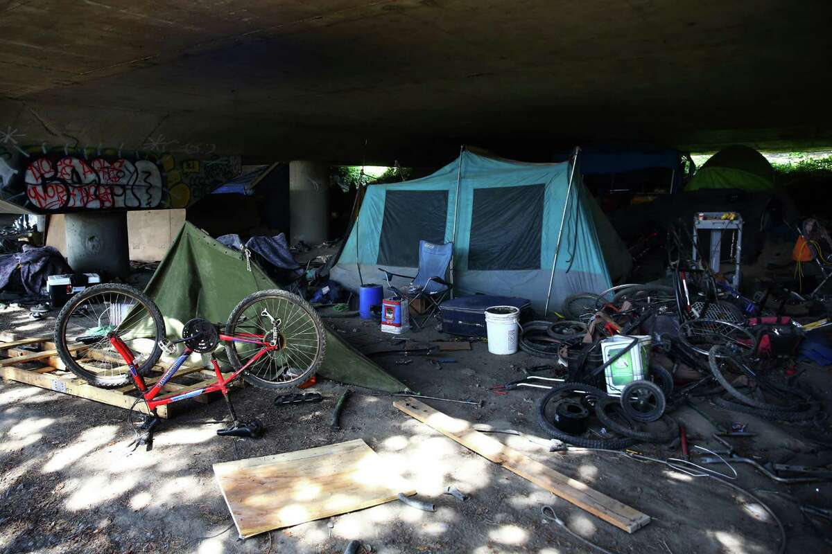 Bicycle parts and trash are scattered around a campsite in The Jungle, an area under I-5 inhabited by hundreds of Seattle's homeless, Tuesday, May 31, 2016.