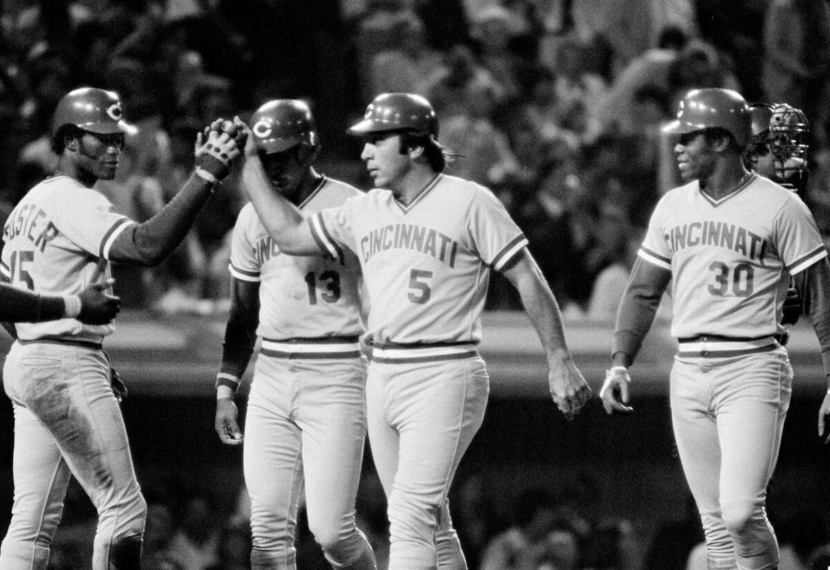 FILE PHOTO: Cincinnati Reds' catcher Johnny Bench (5) gets a high-five from George Foster, left, as he and Dave Concepcion (13) and Ken Griffey (30) all scored on Bench's grand-slam home run over the left field wall against the Los Angeles Dodgers, at Dodger Stadium, Sept. 20, 1980. (AP Photo/Reed Saxon)