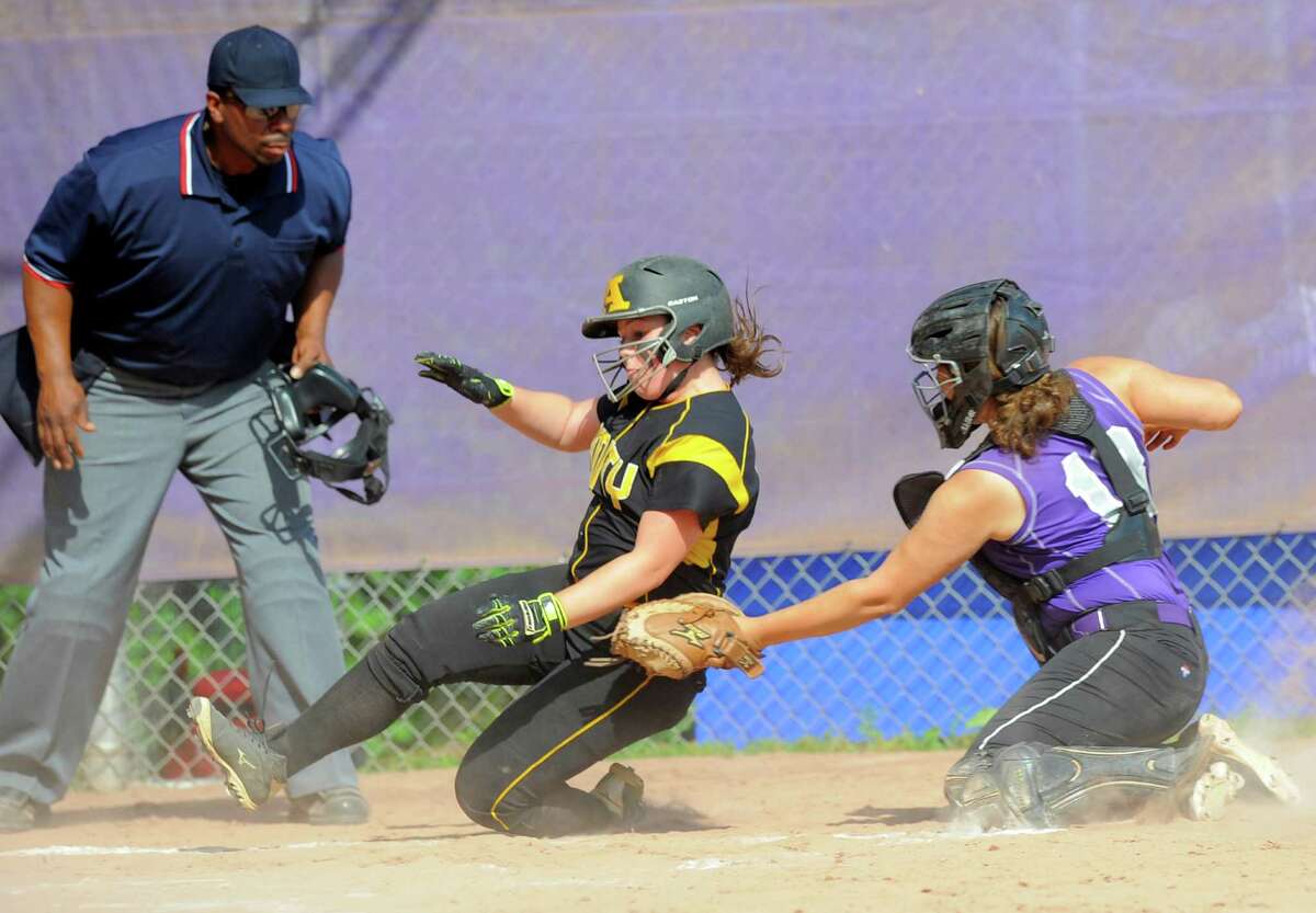 Umpire Thomas Oliver has a clear view as Westhill Jordan Benzaken puts the tag for the out on Amity Alessandra Gusmano in a CIAC Class LL Softball quarterfinal game at Westhill High School in Stamford on June 2, 2016. Amity defeated Westhill 7-0.