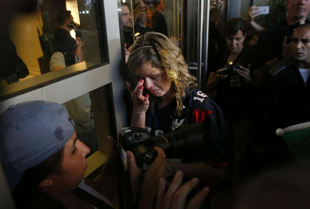 A Donald Trump supporter tries to clear her eyes after being cornered by an anti-Trump crowd and getting hit by multiple eggs near the convention center where presidential candidate Donald Trump held a campaign rally June 2, 2016 in downtown San Jose, Calif.