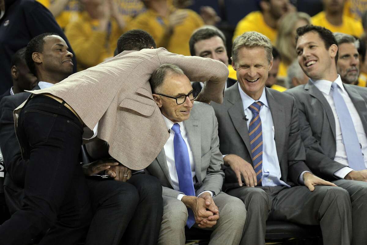 Stephen Curry leans over and hugs Assistant Coach Ron Adams on the bench as the Golden State Warriors played the Houston Rockets in Game 5 of the first round of the Western Conference playoffs at Oracle Arena in Oakland, Calif., on Wednesday, April 27, 2016. The Warriors won 114-81, to advance to the second round.
