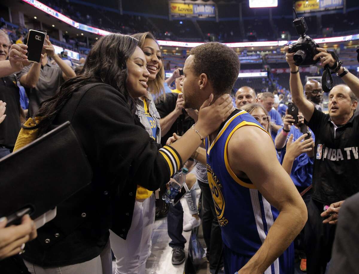 Stephen Curry (30) leans in to kiss his wife Ayesha Curry after the Golden State Warriors defeated the Oklahoma City Thunder 106-101 in Game 6 of the Western Conference Finals at Chesapeake Energy Arena in Oklahoma City, Okla., on Saturday, May 28, 2016.