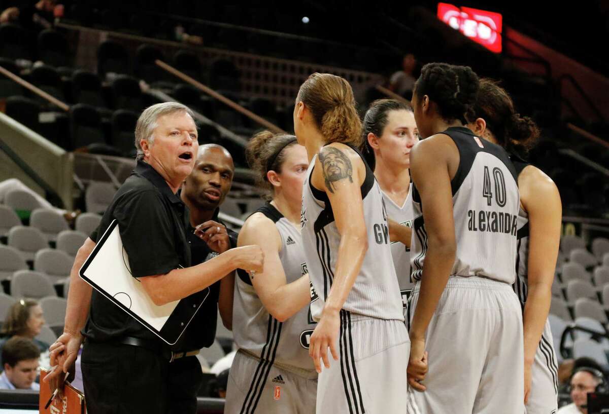 San Antonio head coach Dan Hughes meets with his team during a time out in game against the Los Angeles Sparks on May 9, 2016.