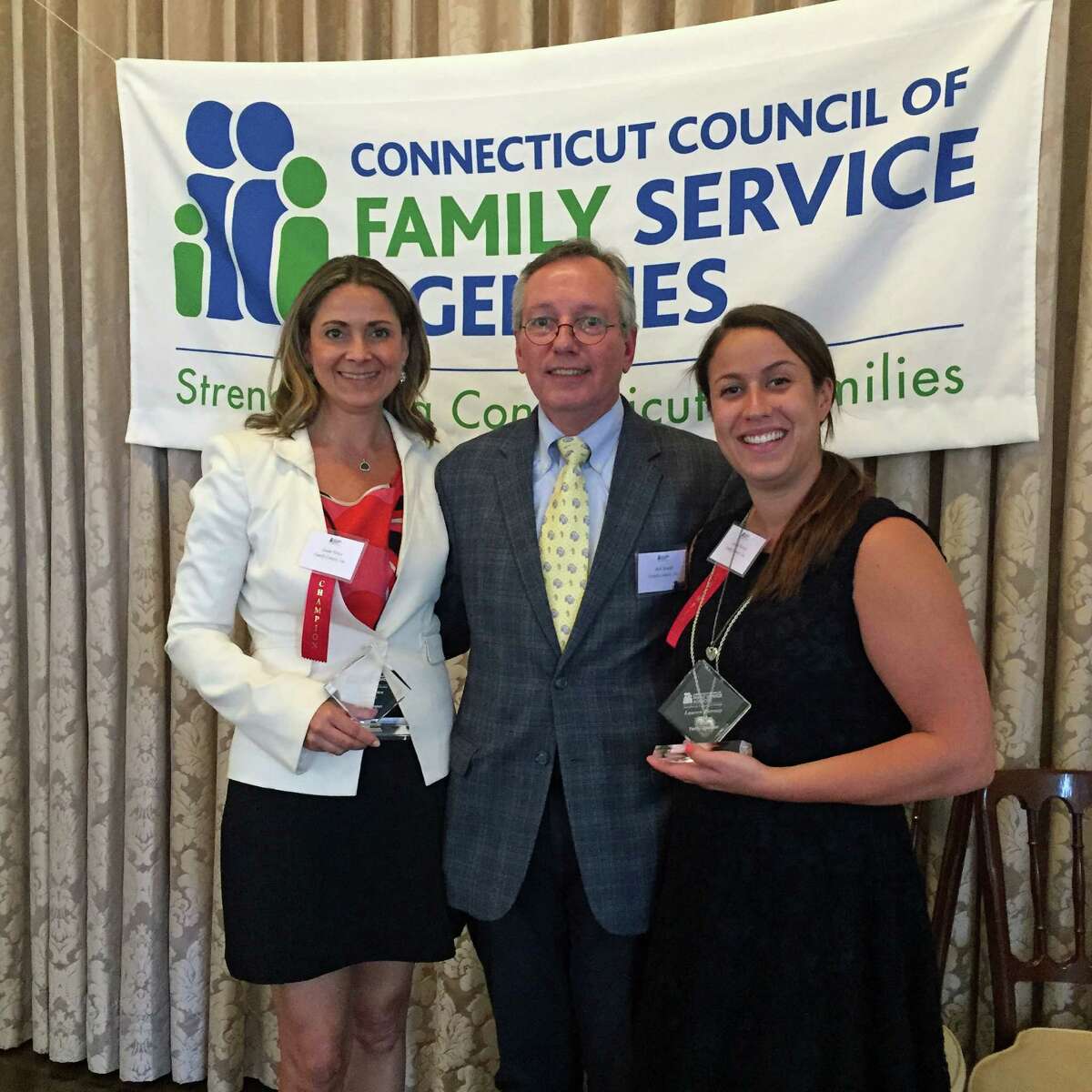 Family Centers?’ board member Susan Yonce (left) and staff member and Stamford resident Lauren Tierney (right) were recognized as ?“Family Champions?” by the Connecticut Council of Family Service Agencies for their outstanding commitment to improving the lives of families at a ceremony held in New Haven on June 2. Shown here with Family Centers?’ President Bob Arnold, they were among 28 human services professionals and volunteers whose unselfish actions have strengthened families in Connecticut. Since joining Family Centers?’ Board of Directors in 2010, Yonce, of Greenwich, has served as a co-chair of three Family Centers?’ annual benefits, which have collectively raised more than $2.1 million to the support the agency?’s health, human service and education programs. She has also co-chaired two successful luncheon fundraisers to benefit the bereavement and critical illness support offered by Family Centers?’ Center for HOPE and The Den for Grieving Kids programs. She also serves as Family Centers?’ current Board Secretary.