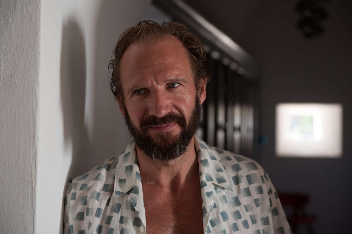In an undated image, the actor Ralph Fiennes in a scene from A Bigger Splash. Sometimes, a movie succeeds as much because of its style as its story, and Fiennes' character has a bag of designer clothes to show off, including one distinctive white, green and gray short-sleeve shirt from Christophe Lemaire that he wears while dancing around to the Rolling Stones Emotional Rescue.
