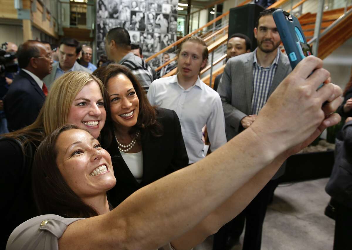 Attorney General Kamala Harris, third from left, takes a poto with Alissa Harris, second from left, and Meiling Hunter, left, after a news conference where Gov. Jerry Brown endorsed Harris in the U.S. Senate race, in Sacramento, Calif., Monday, May 23, 2016. Harris is running against fellow Democrat, Rep. Loretta Sanchez, among others, to replace Barbara Boxer who is retiring. (AP Photo/Rich Pedroncelli)