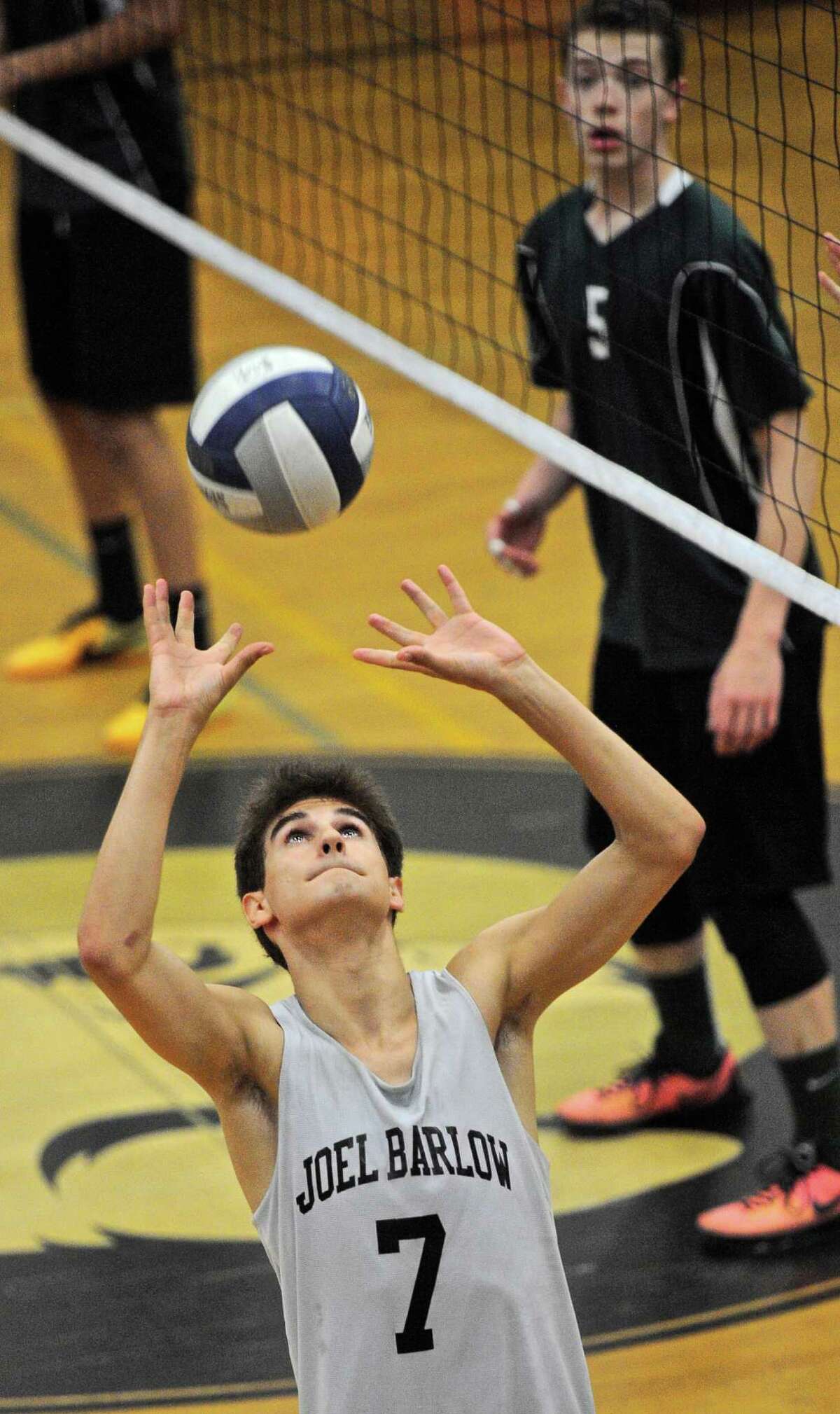 Joel Barlow's Austin Houser (7) sets the ball in the State Class M boys volleyball quarterfinal game between Enfield and Joel Barlow high schools, on Friday night, June 3, 2016, at Joel Barlow High School, Redding, Conn.