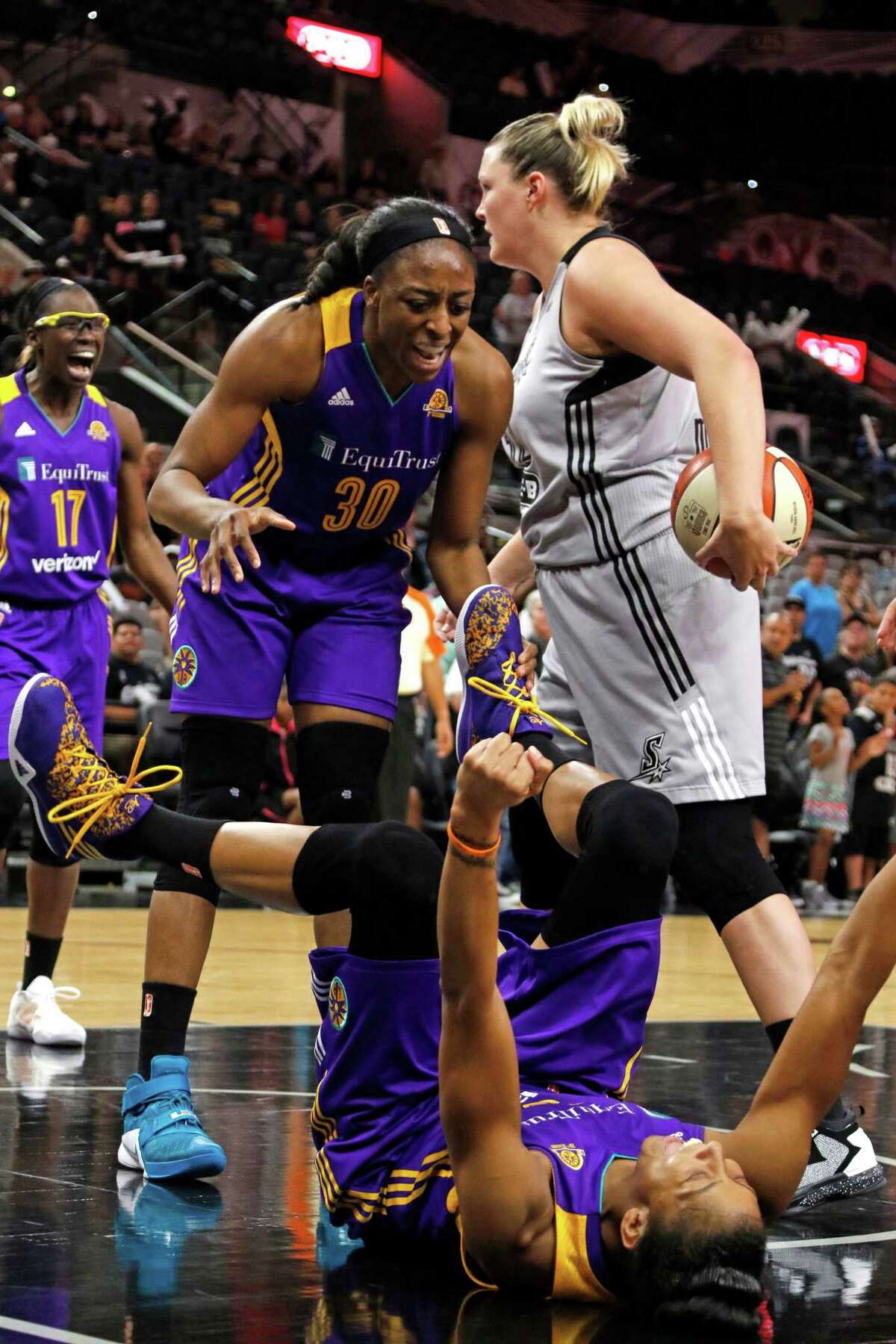 Los Angeles Sparks Candace Parker celebrates with Los Angeles Sparks Nneka Ogwumike after she drew the charge from San Antonio Stars?• Jayne Appel-Marinelli Saturday, June 4, 2016 at AT&T Center.
