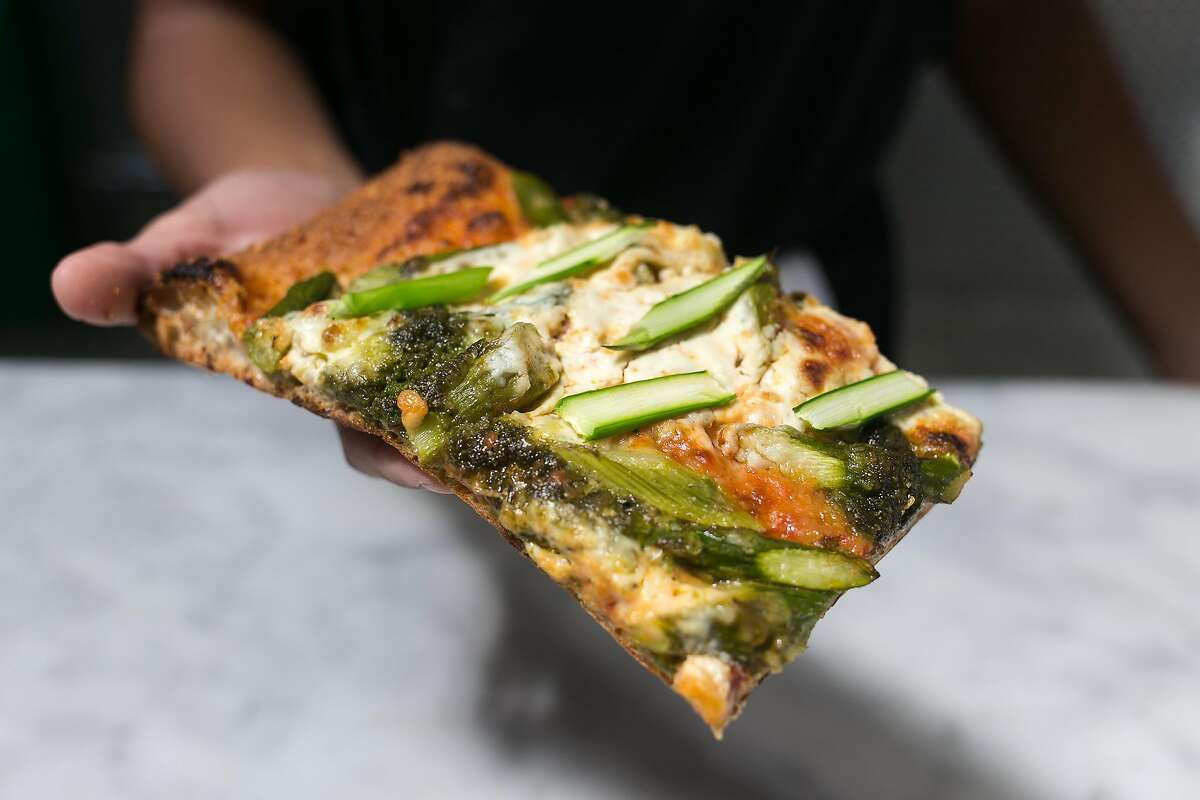 Pizza with pesto, asparagus and ricotta at The Den in S.F.