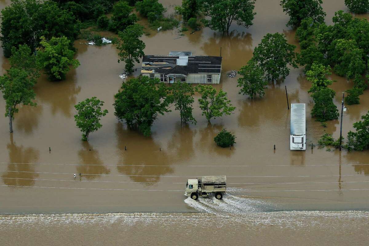 A rescue vehicle drives down FM 1462 as the Brazos River floods Saturday, June 4, 2016 in Rosharon.