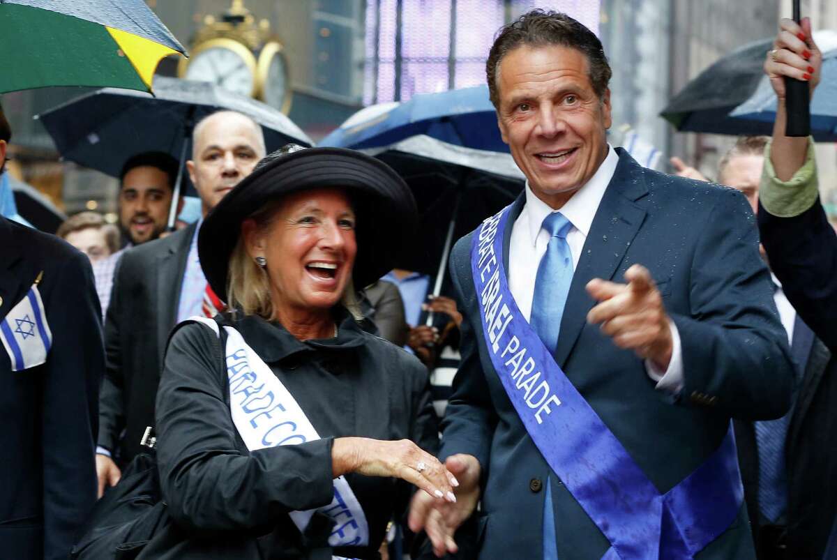 New York Gov. Andrew Cuomo, right, points into the crowd while marching in the annual Celebrate Israel parade along Fifth Avenue, Sunday, June 5, 2016, in New York. (AP Photo/Kathy Willens) ORG XMIT: NYKW108
