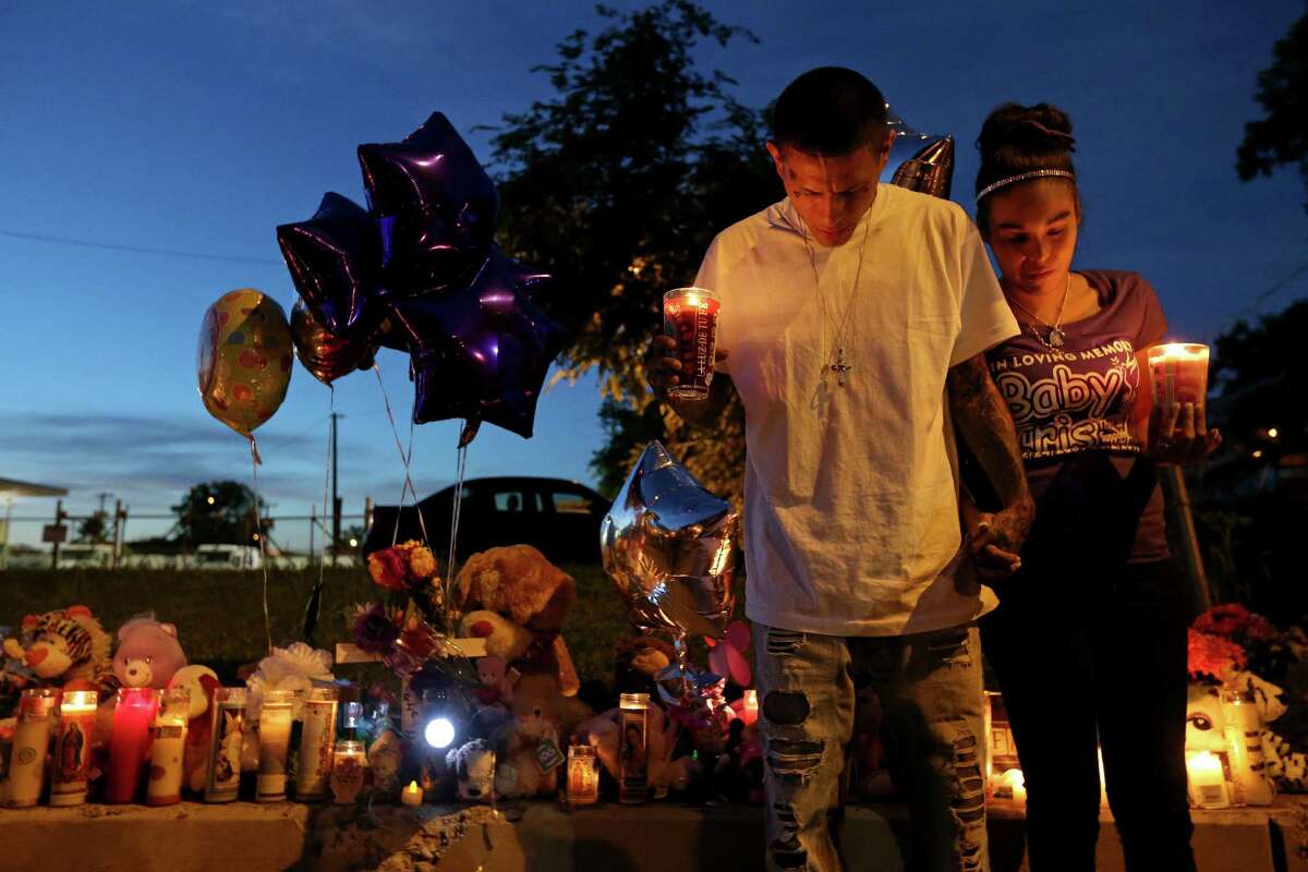 Victor Badillo and his wife Eva Juarez pray during a candlelight vigil held Sunday June 5, 2016 in remembrance of their 7-year-old daughter Iris Rodriguez who was fatally shot in the 5500 block of San Fernando Street Wednesday June 1, 2016 and died at University Hospital Thursday evening.
