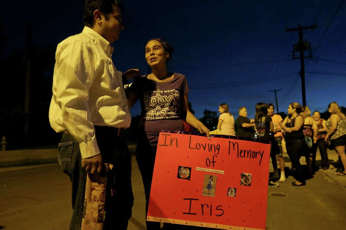 Margil Elementary School music teacher Juan Saldana (left) talks with Eva Juarez after a candlelight vigil held Sunday June 5, 2016 in remembrance Eva's 7-year-old daughter Iris Rodriguez who was fatally shot in the 5500 block of San Fernando Street Wednesday June 1, 2016 and died at University Hospital Thursday evening. Saldana was Iris' music teacher.