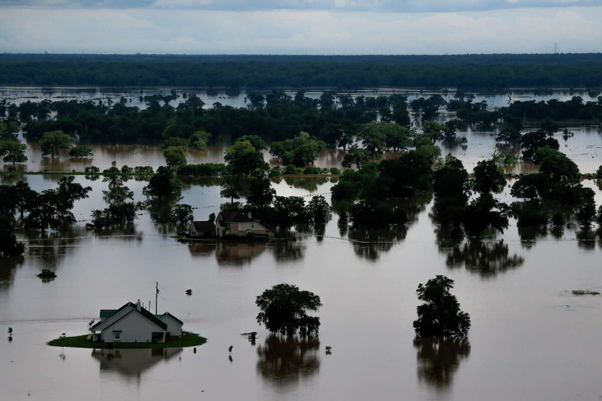 Aerial photos capture cowboys, flooded homes as floods plague Houston