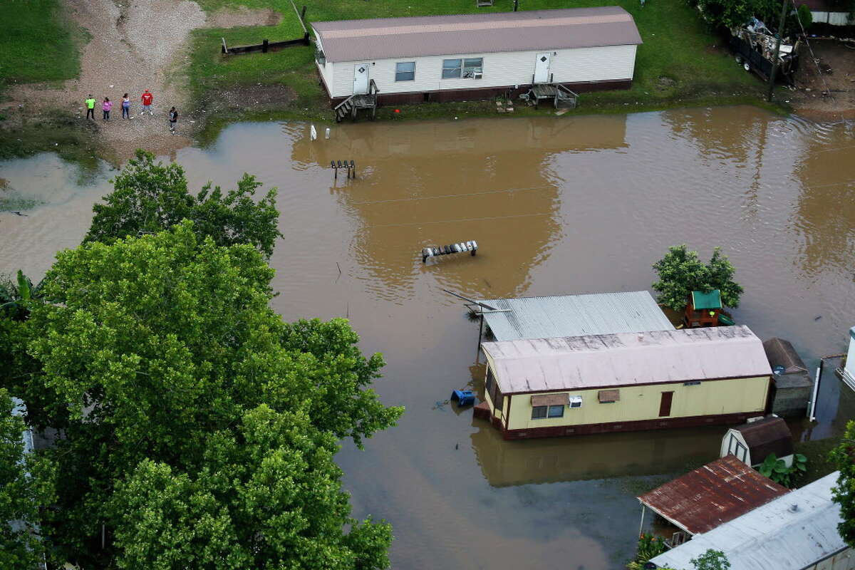 Aerial photos capture cowboys, flooded homes as floods plague Houston