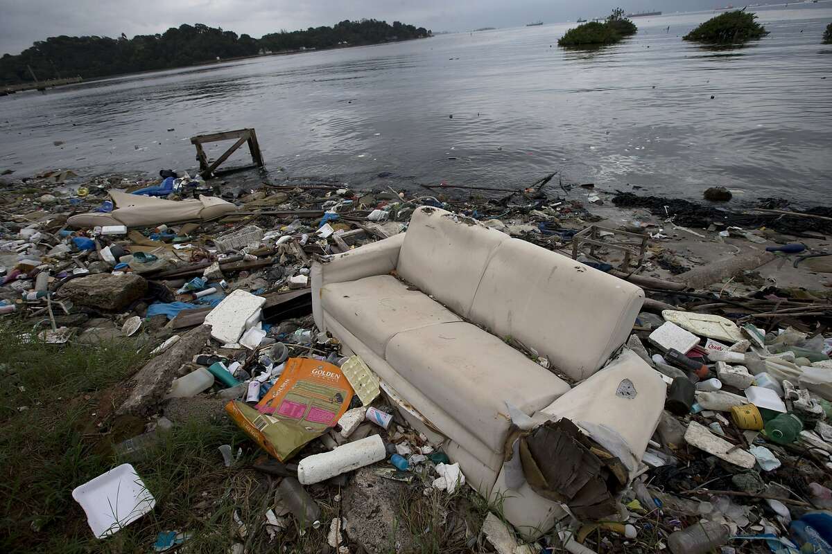 In this June 1, 2015 file photo, a discarded sofa litters the shore of Guanabara Bay in Rio de Janeiro, Brazil. 