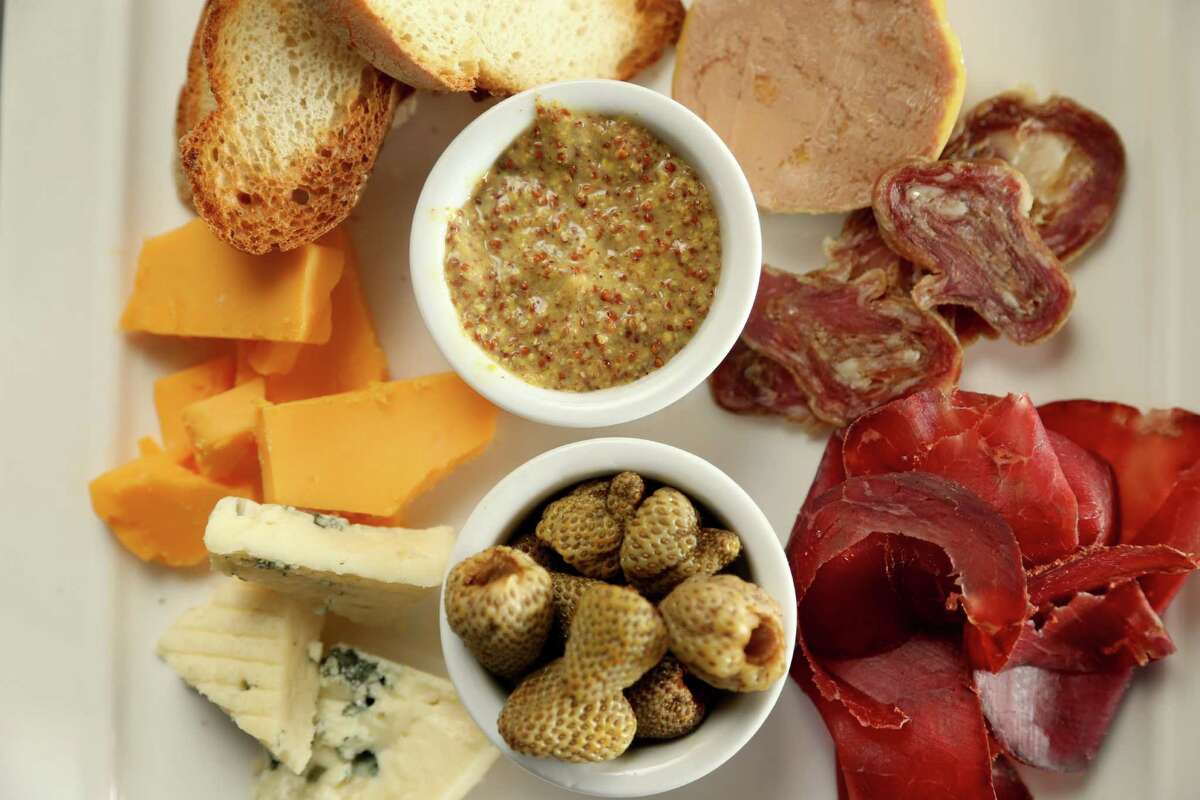 Harold's Tap Room's charcuterie and cheese spread consists of Houston Dairymaids cheeses, cured meats, foie gras, pickled vegetables, mustard and bread.