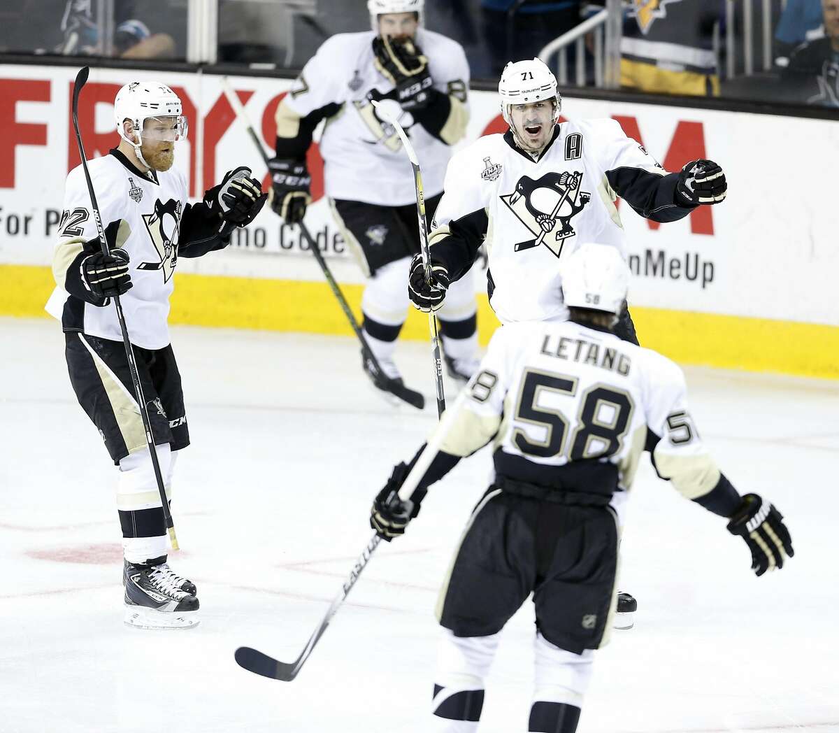 Pittsburgh Penguins' Evgeni Malkin celebrates his goal with Patric Hornqvist and Kris Letang in 2nd period against San Jose Sharks of Game 4 of Stanley Cup Final at SAP Center in San Jose, Calif., on Monday, June 6, 2016.