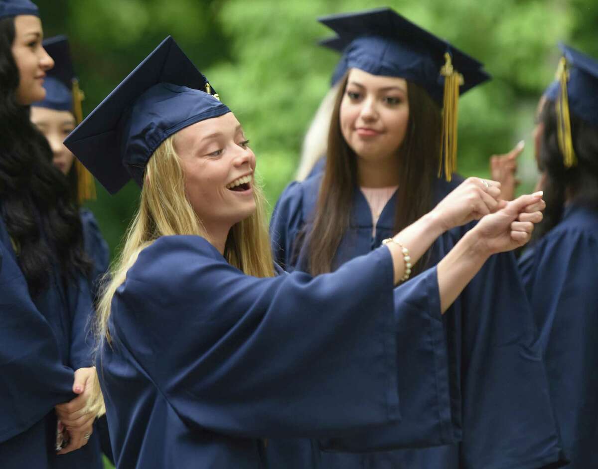 Bayley McKeon, of West Haven, dances around before the Notre Dame High School commencement ceremony at Notre Dame High School in Fairfield, Conn. Friday, June 3, 2016.