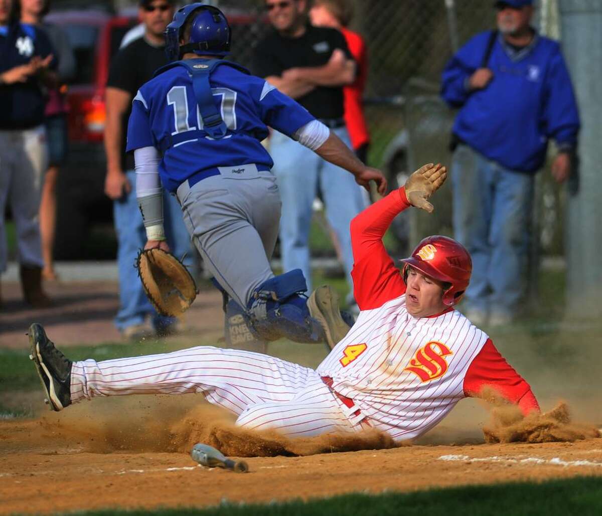 Stratford's Jordan Weiss scores from third on a sacrifice fly in the 6th inning of Stratford's 5-0 win over rival Bunnell at Penders Field in Stratford on Wednesday, April 21, 2010.