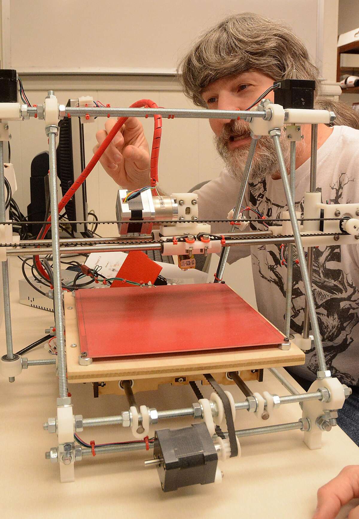 Senior Volunteer coordinator James Husum, of Spring, works on a 3-D Laser printer kit he is making at the Proto Makerspace, 22820 Interstate 45 suite 2D in Spring, weekly open house. Photograph by David Hopper