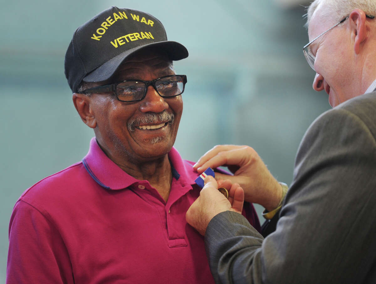 Air Force veteran John Antrum, of Ansonia, is pinned with the Connecticut Veterans Wartime Service Medal by Veterans' Affairs Commissioner Sean Connolly during a ceremony at the Ansonia Armory in Ansonia, Conn. on Tuesday, June 7, 2016. Thirty-two awards were presented during the event.