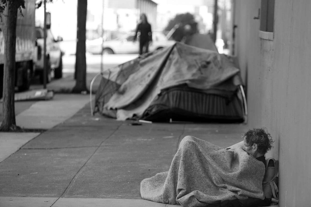 Daniel Pledger rests against a building on Florida Street as he sits under blankets covering him on Friday, April 29, 2016 in San Francisco, California. Pledger says he's been homeless since last August.