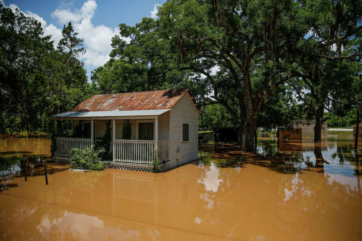 East Columbia, a smaller community than its western neighbor, is entirely submerged, authorities say. A home is surrounded by flood waters Tuesday, June 7, 2016 in East Columbia. ( Michael Ciaglo / Houston Chronicle )