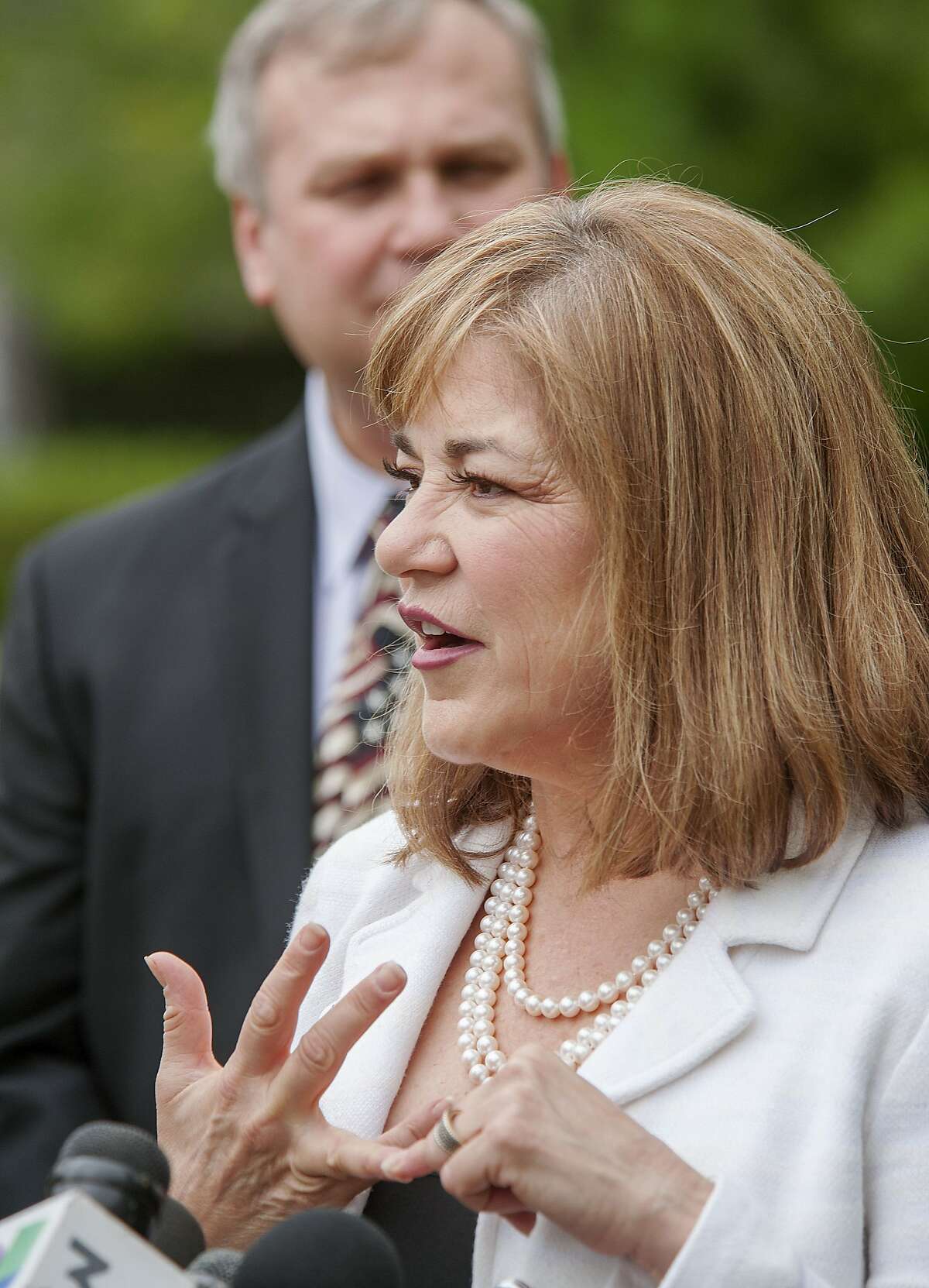 U.S. Rep. Loretta Sanchez answers questions after casting her ballot during a short press conference as her husband Jack Einwechter of Orange listens, Tuesday, June 7, 2016, at Orange High School, in Orange, Calif. Sanchez is running against California Attorney General Kamala Harris for the United States Senate seat replacing retiring Sen. Barbara Boxer. 