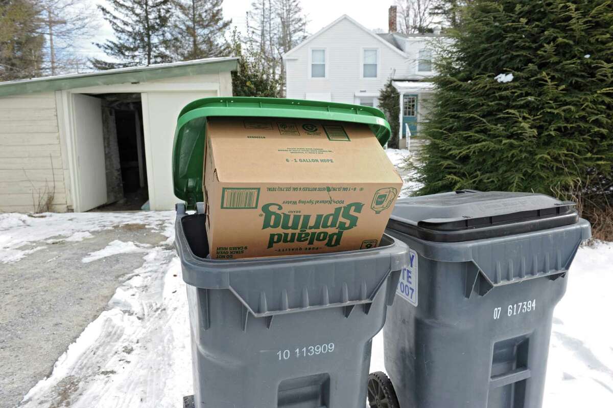 An empty case of Polar spring water is seen in a recycling receptacle in front of a house on Friday, Feb. 12, 2016 in Hoosick Falls, N.Y. (Lori Van Buren / Times Union)