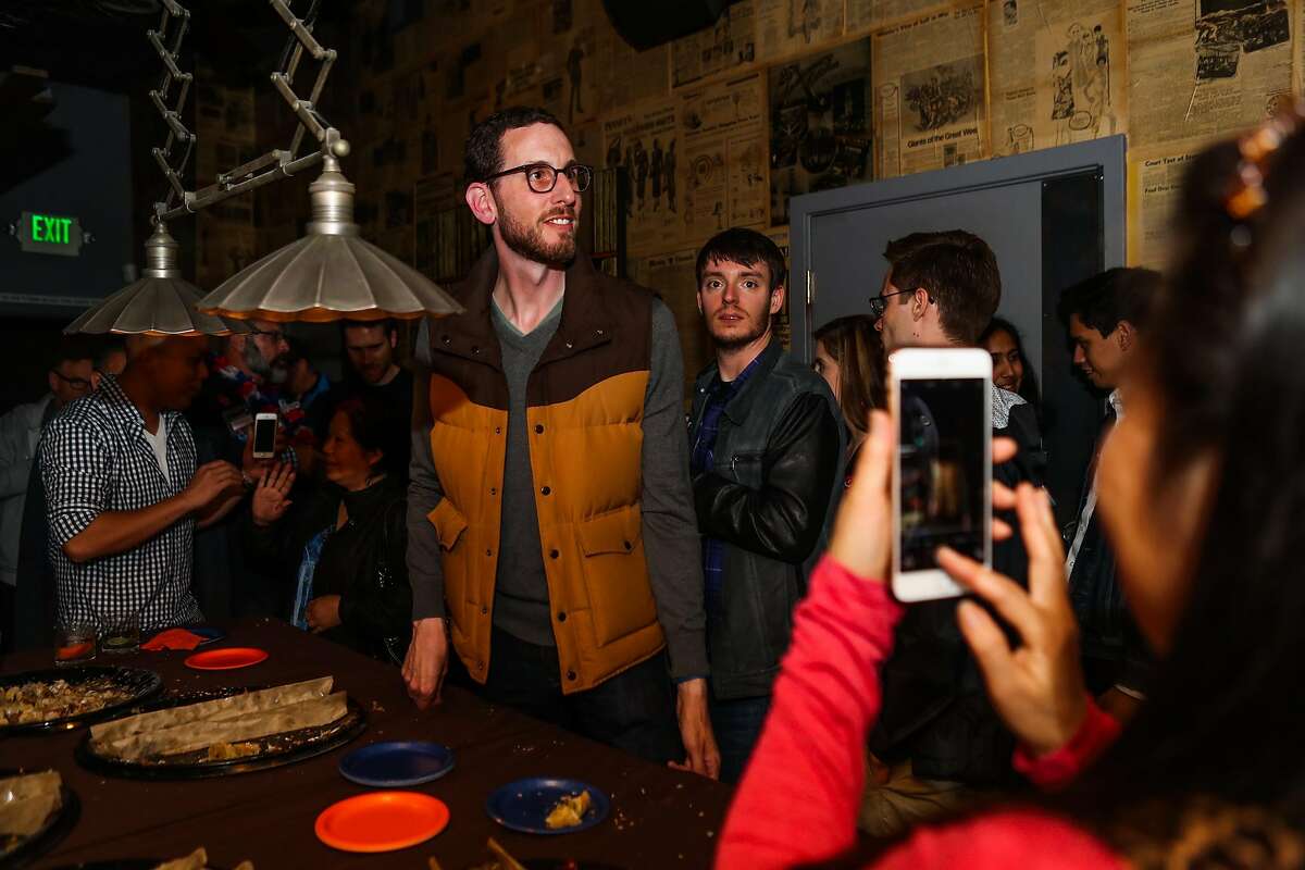 A woman photographs Supervisor Scott Wiener (left), who is running for State Senate during his election party, at Blackbird, in San Francisco, California, on Tuesday, June 7, 2016.