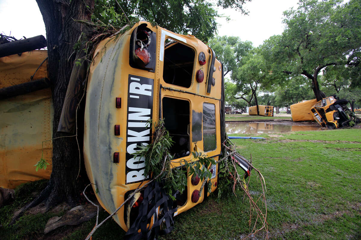 Buses from Rockin' "R" River Rides are wrapped around trees along the banks of the Guadalupe in Gruene. Flooding in New Braunfels on June 9, 2010. Tom Reel/Staff