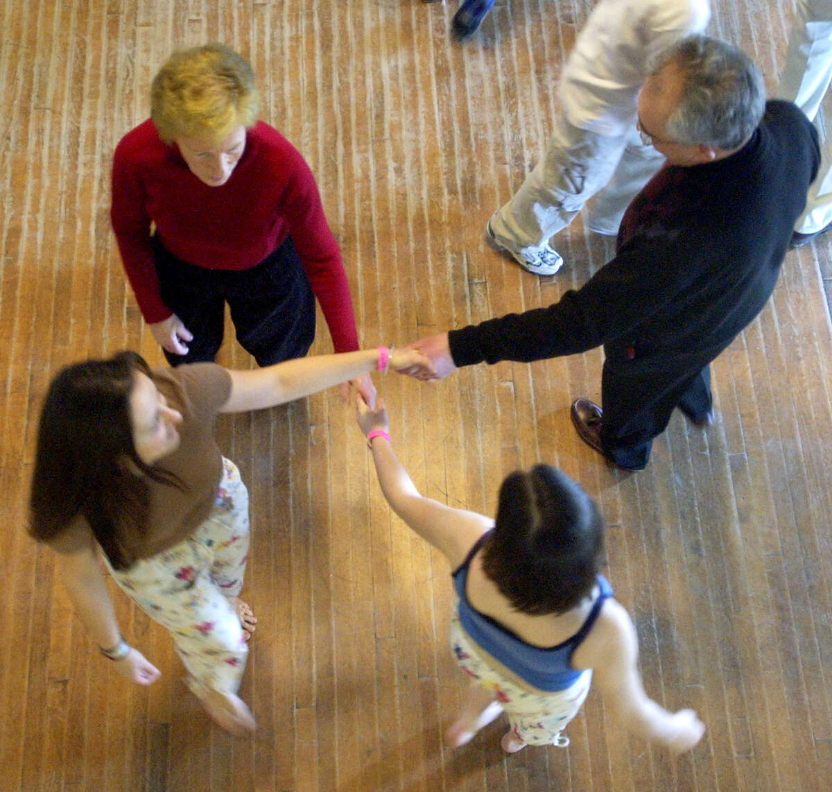 TIMES UNION STAFF PHOTO WILL WALDRON--Dance Flurry, dancers cross hands during a work shop entitled Contras for novices, at the Saratoga Music Hall, Saturday, February 14, 2004.