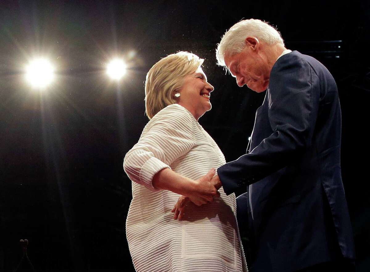 Democratic presidential candidate Hillary Clinton, second from right, greets her husband, former president Bill Clinton during a presidential primary election night rally, Tuesday, June 7, 2016, in New York. (AP Photo/Julie Jacobson)