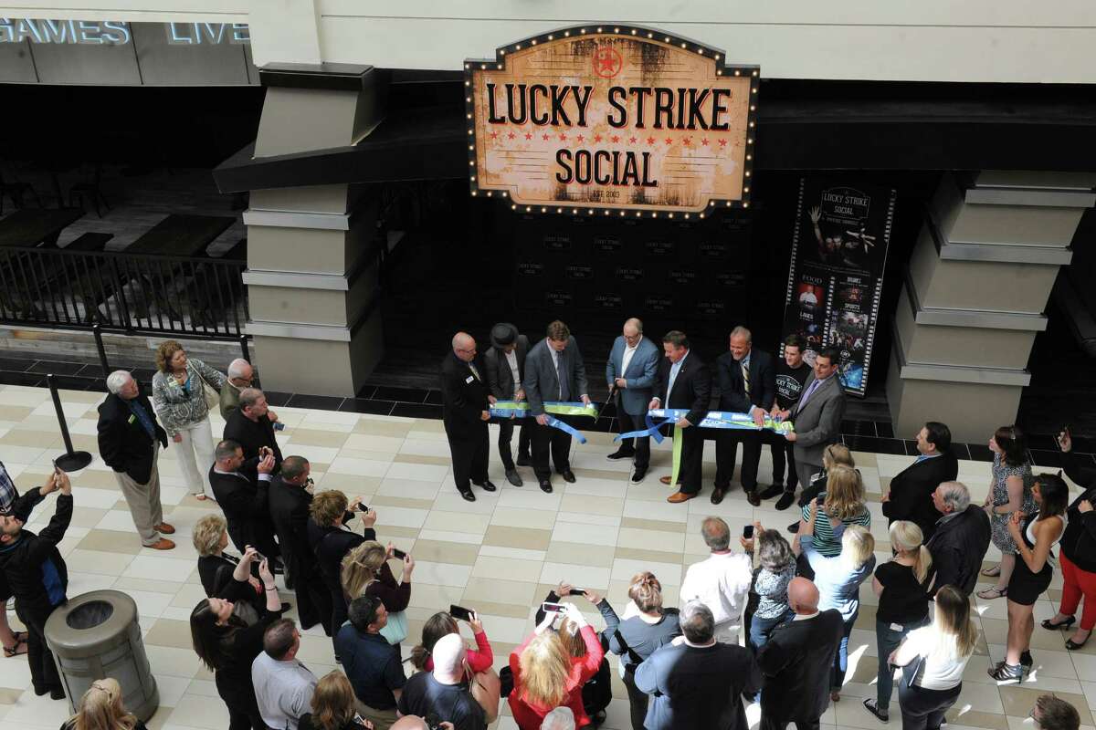 Owner Steven Foster cuts the ribbon as Lucky Strike Social opens for a VIP party on Thursday night and to the general public Friday on Thursday June 9, 2016 in Guilderland, N.Y. (Michael P. Farrell/Times Union)